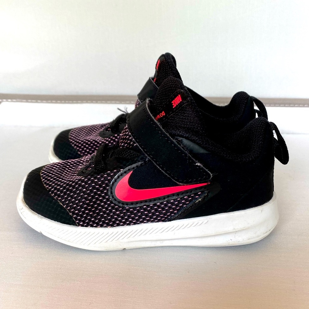 Hot pink and black toddler Nike sneaker. Worn.
